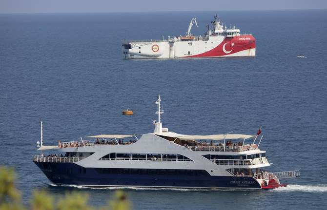 Turkish seismic research vessel Oruc Reis, background, anchored off Turkey’s southern coast on Sunday, easing eastern Mediterranean tensions a bit. (AP)