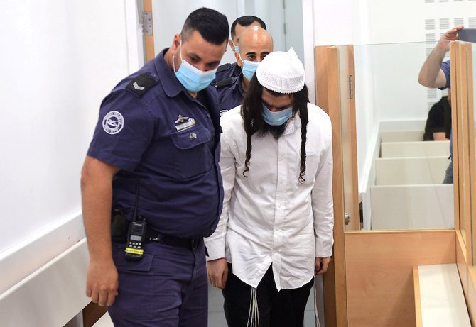 Amiram Ben-Uliel is brought for a verdict in the case of the 2015 arson attack, which killed a Palestinian toddler and his parents in the Israeli-occupied West Bank village of Duma, at the Central Lod District Court in Lod, Israel May 18, 2020. (Reuters)