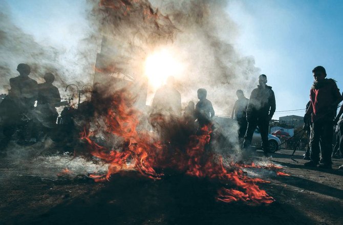 Palestinian demonstrators burn tires during a protest against the Middle East peace plan, in Rafah in the southern Gaza Strip. (AFP)