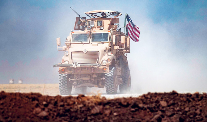A US military vehicle patrols near the Rumaylan oil fields in Syria’s northeastern Hasakeh province, as Washington stepped up its military deployment in the area. (AFP)