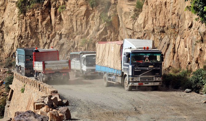 Vehicles are pictured on a damaged road, the only travel route between Yemen’s cities of Taiz and Aden. Yemen has been left in ruins by six years of war, where over 24 million people are in need of aid and protection. (AFP)