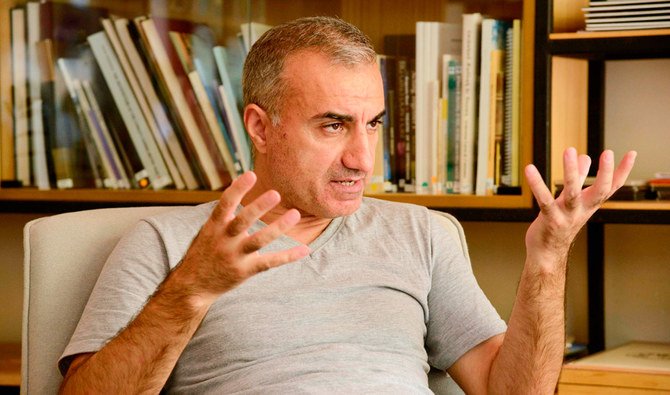 Iranian singer Omid Tootian, 46, gestures during an interview at a coffee shop in the UN-controlled buffer zone in the Cypriot capital Nicosia, on September 23, 2020, where he's been stuck since mid-September. (AFP)