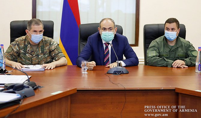 Armenian Prime Minister Nikol Pashinyan meets with top military officials in Yerevan on September 27, 2020. Arch foes Armenia and Azerbaijan on September 27, 2020 accused each other of initiating deadly clashes that claimed at least 23 lives over a decades-long territorial dispute and threatened to draw in regional powers Russia and Turkey. (AFP)