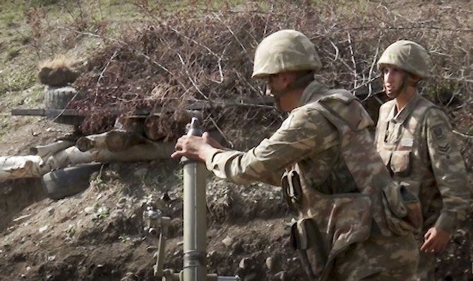 In this image taken from footage released by Azerbaijan's Defense Ministry on Sunday, Sept. 27, 2020, Azerbaijan's soldiers fire from a mortar at the contact line of the self-proclaimed Republic of Nagorno-Karabakh, Azerbaijan. (AP)