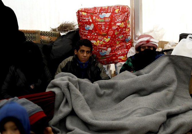 Syrian displaced kids shield themselves from the cold inside a tent in the Internally Displaced Persons (IDP) camp of al-Hol in al-Hasakeh governorate. (File/AFP)