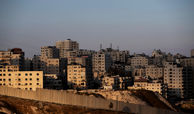 Building in the Palestinian town of Anata in the Israeli-occupied West Bank, are seen behind the Israeli barrier, as seen from Jerusalem September 23, 2020. (Reuters)