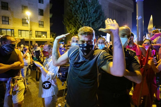 Thousands of Israelis gathered in Jerusalem to demand the resignation of Prime Minister Benjamin Netanyahu, a day after the country tightened its lockdown aimed at slowing coronavirus spread. (AFP)