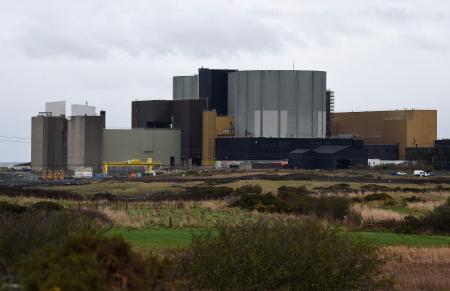 This file photo taken on January 18, 2019 shows the Wylfa Newydd nuclear power station beyond a farmer's field in Anglesey in northwest Wales. Hitachi said on September 16, 2020 it is pulling out of a multi-billion-pound nuclear power plant project in Wales, citing a worsening investment environment, in a blow to Britain's low-carbon energy policy. (AFP)