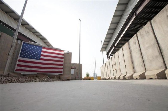 A US flag hangs from blast barriers guarding the entrance to the dining facility inside the compound of the US embassy in Baghdad, December 14, 2011. (Reuters)