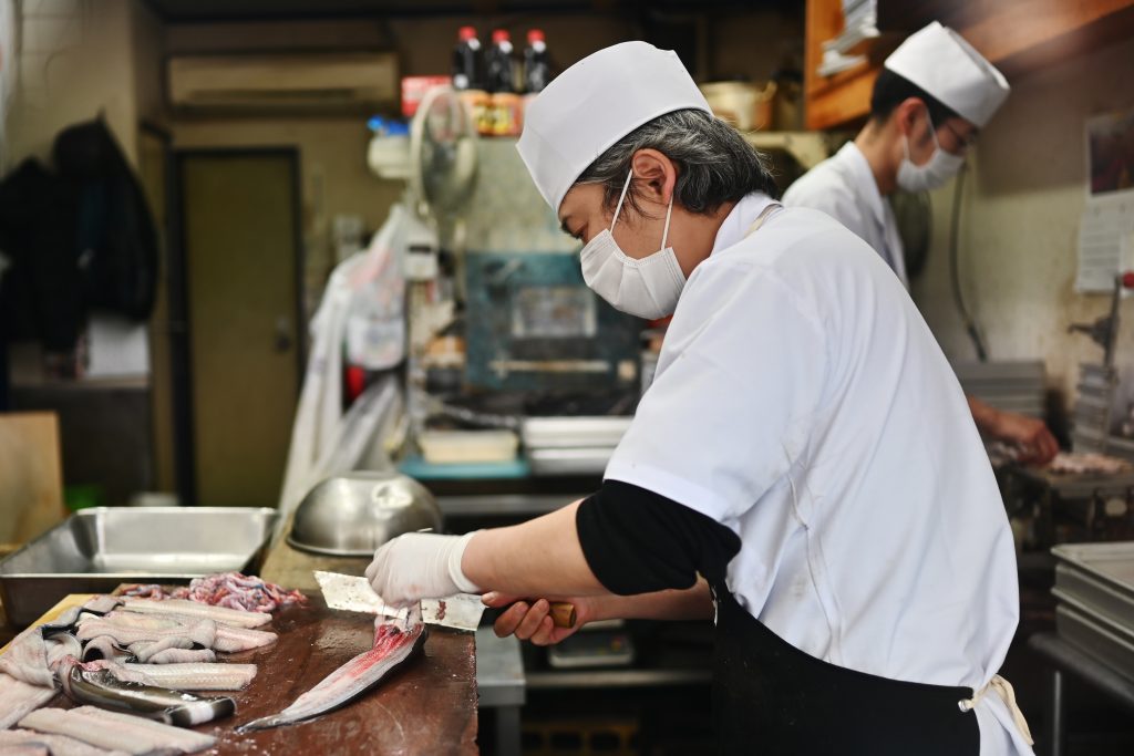 When judging the quality of fish, buyers look at how fresh and firm the meat is and how much fat it puts on. (AFP)