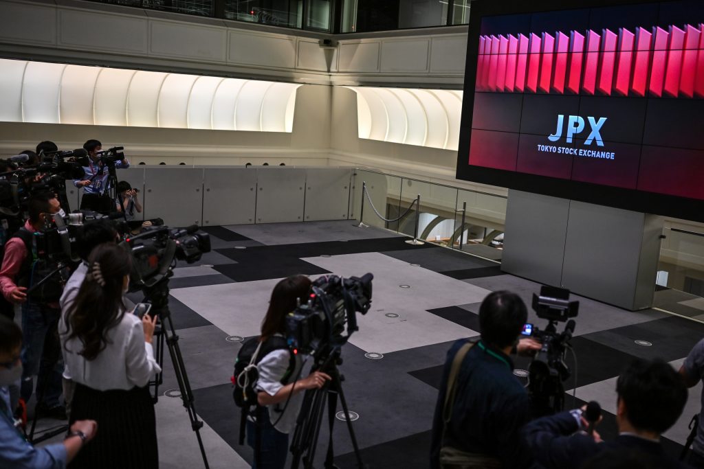 Journalists film during the reopening of the Japan Stock Exchange in Tokyo on October 2, 2020, after a 