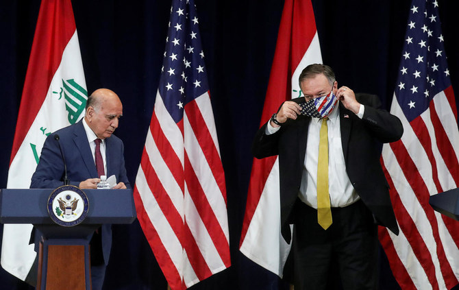 US Secretary of State Mike Pompeo puts on a protective face mask as he and Iraq's Foreign Minister Fuad Hussein face reporters at the State Department in Washington, US, August 19, 2020. (Reuters)