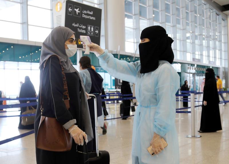 The temperature of a passenger is checked at Riyadh International Airport, after Saudi Arabia reopened domestic flights, May 31, 2020. (Reuters)