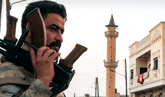 A Syrian rebel fighter looks on while on guard duty in the west of Tal Abyad in Raqqa province, along the front-line with Syrian Kurdish forces. (AFP)