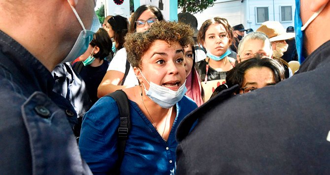 Activists rally in Algiers on Thursday to denounce the brutal murder of a 19-year-old woman and those of the 38 other women killed this year. (AFP)