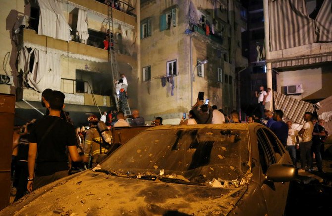 Rescuers evacuate people from their buildings after a fuel tank exploded in the Tariq Jadida neighborhood of Beirut, Lebanon on Oct. 9, 2020. (Reuters)