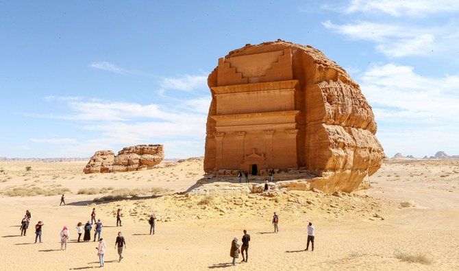 Visitors are seen in front of Qasr al-Farid tomb at the Madain Saleh antiquities site in Al-Ula, Saudi Arabia, January 31, 2020. (REUTERS)