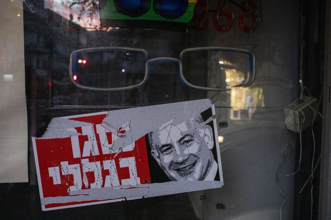 A poster reads ‘closed because of me’” with an image of Israel’s Prime Minister Benjamin Netanyahu on a closed shop in Tel Aviv on Tuesday, Oct. 13, 2020. (AP)