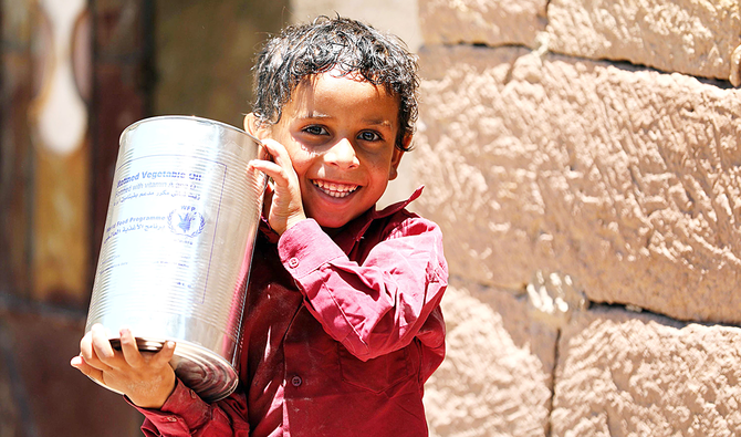 A Yemeni child receives humanitarian aid in the city of Taez. Yemen’s officials have thanked Saudi Arabia for bridging differences between two groups. (AFP)
