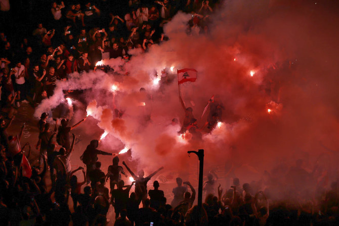 Anti-government protesters light flares and chant slogans against the Lebanese government, in Beirut, Lebanon on Nov. 3, 2019. (File/AP)