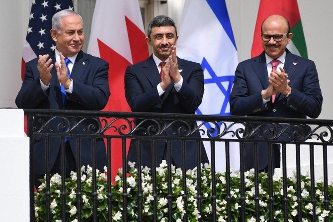 (L-R)Israeli Prime Minister Benjamin Netanyahu,UAE Foreign Minister Abdullah bin Zayed Al-Nahyan and Bahrain Foreign Minister Abdullatif al-Zayani applaud before they participate in the signing of the Abraham Accords. (File/AFP)