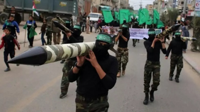 Palestinian militants from the Ezzedine al-Qassam brigade, the armed wing of Hamas, carry mock rockets at a rally at the Nuseirat refugee camp in the Gaza Strip on December 12, 2014. (AFP File Photo)