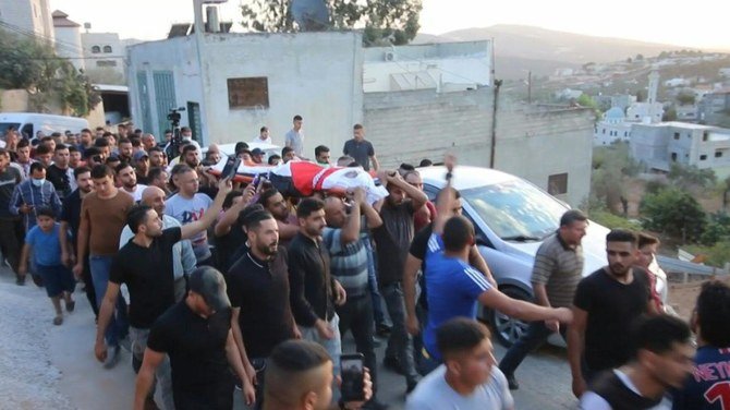 Palestinian mourners hold the funeral of Amer Abdel-Rahim Sanouber, who died after a confrontation with Israeli troops, with the army saying it happened while trying to flee, in the village of Yatma in the occupied West Bank. (AFP)