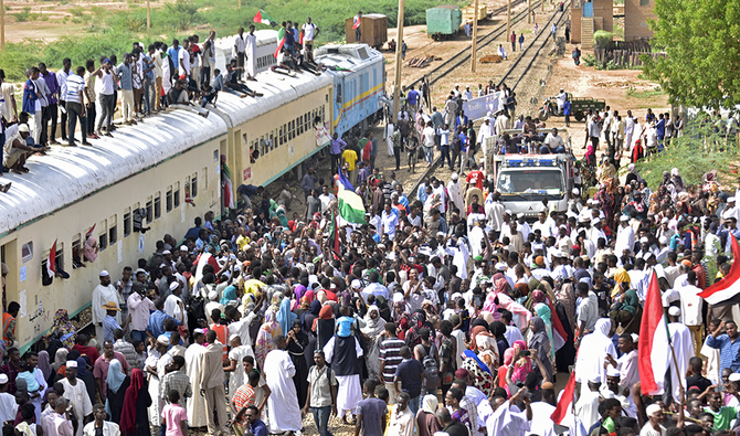 Sudanese protesters from the city of Atbara arrive at the Bahari station in Khartoum last year to celebrate transition to civilian rule. (File/AFP)