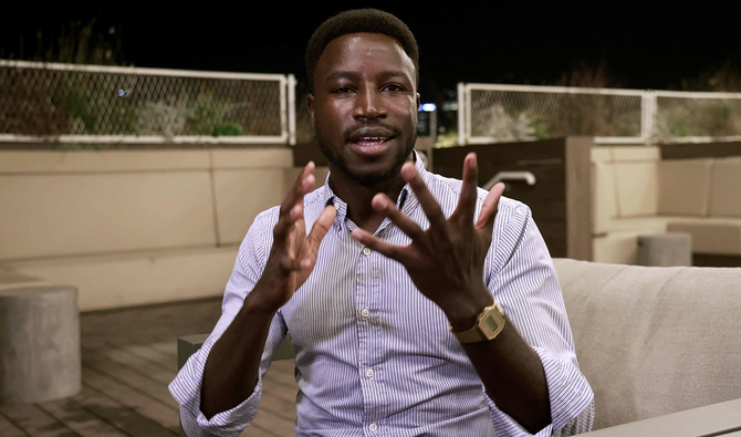 Sudanese asylum seeker and head of the African Students Organization in Israel Usumain Baraka speaks during an interview in Tel Aviv. (AFP)