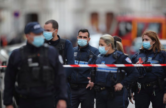 Police officers stand guard near the Notre Dame church in Nice, southern France, after a knife attack killed three on Thursday. (AP)