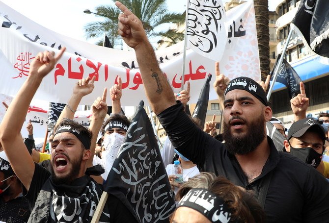 Demonstrators gesture during a protest against the cartoon publications of Prophet Mohammad in France and comments by the French President Emmanuel Macron, in Beirut. (AFP)