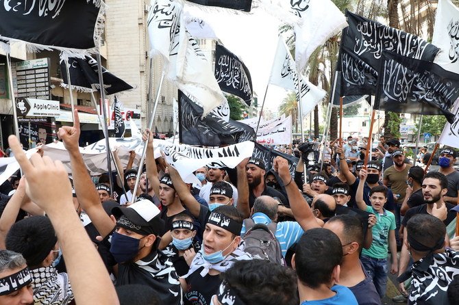  Demonstrators gesture and chant slogans during a protest against the cartoon publications of Prophet Mohammad in France and comments by the French President Emmanuel Macron, in Beirut. (Reuters)