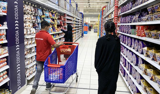 A woman shops for snacks at a supermarket in Saudi Arabia's capital Riyadh on October 18, 2020. (AFP)