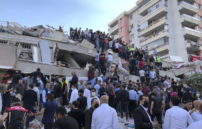 At least 20 buildings in Izmir were destroyed, authorities said, and the rescue work was taking place as hundreds of aftershocks hit the area. (AP/Ismail Gokmen)