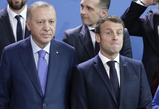 In this Sunday, Jan. 20, 2020 file photo, Turkey's President Recep Tayyip Erdogan (left) and French President Emmanuel Macron stand, during a group photo at a conference on Libya at the chancellery in Berlin, Germany. (AP)