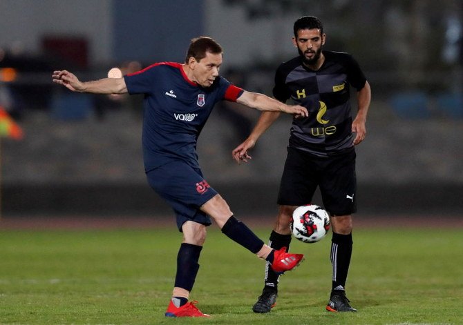 Ezzeldin Bahader, a 74-year-old Egyptian football player of 6th October Club is seen in action during a soccer match against El Ayat Sports Club of Egypt's third division league at the Olympic Stadium in the Cairo suburb of Maadi, Egypt October 17, 2020. Picture taken October 17, 2020. (Reuters)