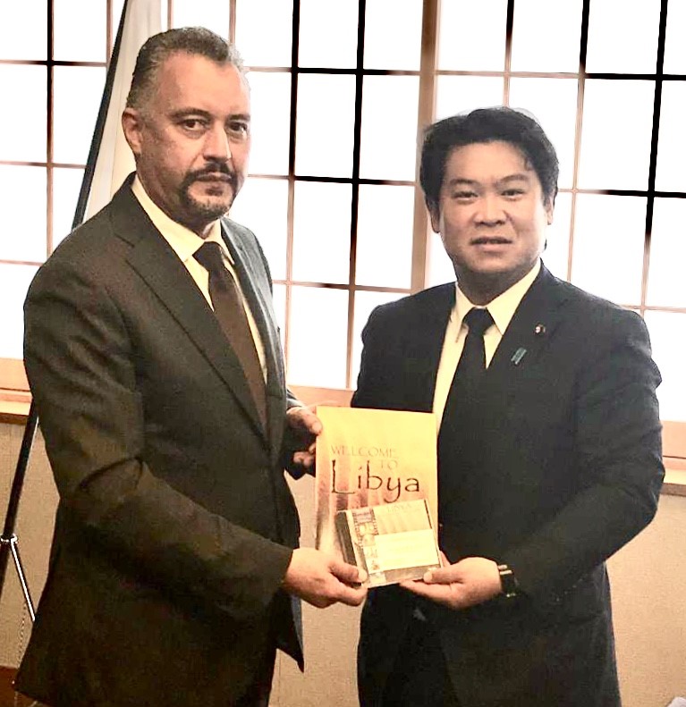 Al Naili (left) gives Japan’s deputy foreign minister Eichiro Washio publications on the resources in Libya. (Supplied photo)