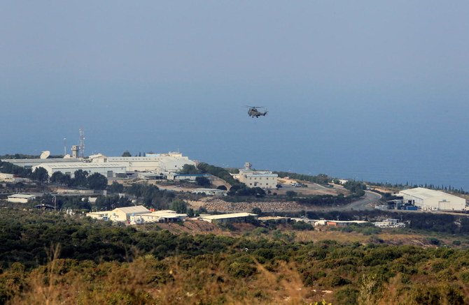 An aircraft flies over a base for UN peacekeepers of the United Nations Interim Force in Lebanon (UNIFIL) in Naqoura, near the Lebanese-Israeli border, southern Lebanon October 29, 2020. (Reuters)