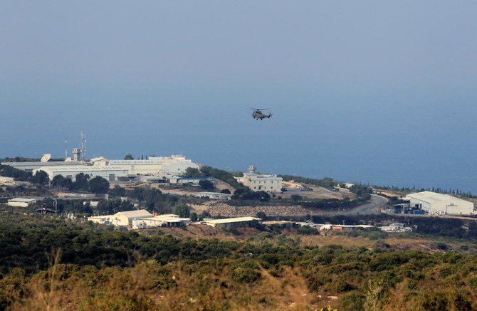 An aircraft flies over a base for UN peacekeepers of the United Nations Interim Force in Lebanon (UNIFIL) in Naqoura, near the Lebanese-Israeli border, southern Lebanon October 29, 2020. (Reuters)