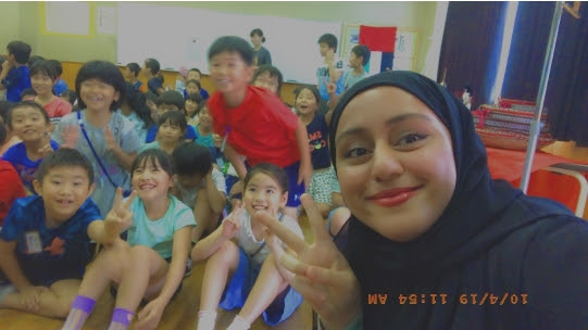 Fatima Al Hindassi with young Japanese students in Japan. (Supplied photo)
