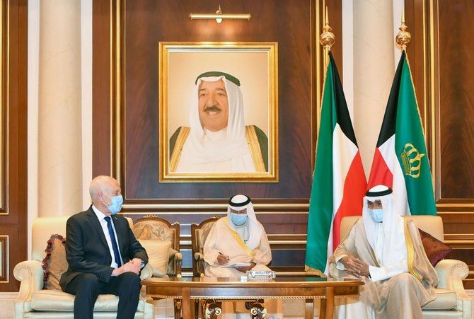 A handout picture released by the press office of the Emir of Kuwait Diwan on October 1, 2020 shows Tunisia's President Kais Saied (left) meeting with Kuwait's new Emir Sheikh Nawaf Al-Ahmad Al-Sabah (right) and offering condolences to the latter, in Kuwait City. (AFP)