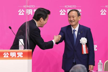 Japan's Prime Minister Yoshihide Suga greets Komeito Party leader Natsuo Yamaguchi (left) as he attends the party's convention as a guest in Tokyo on September 27, 2020. (AFP)