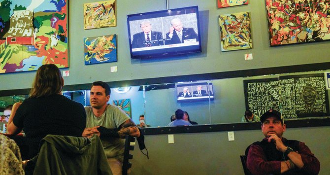 Viewers in Bloomington in the American state of Indiana watch US Republican President Donald Trump and Democratic opponent, former vice president, Joe Biden, during the first debate for the November election. (Getty Images)