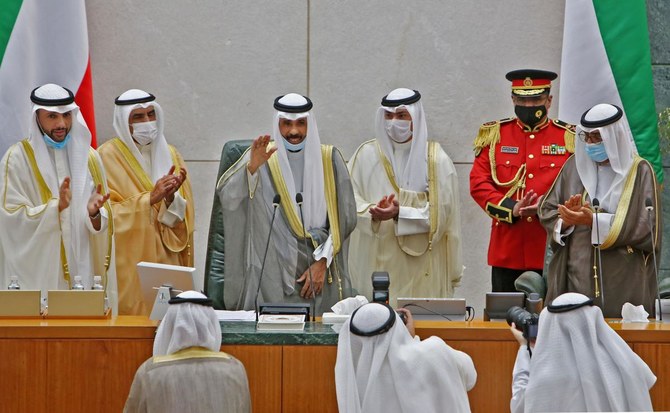 Emir of Kuwait Sheikh Nawaf al-Ahmad al-Jaber al-Sabah (centre) gestures in greeting as he arrives with Crown Prince Sheikh Meshal al-Ahmad al-Jaber al-Sabah (right) and Parliament Speaker Marzouq al-Ghanim (left) to attend the opening of the 5th regular session at the country's National Assembly (parliament) in Kuwait City on October 20, 2020. (AFP)