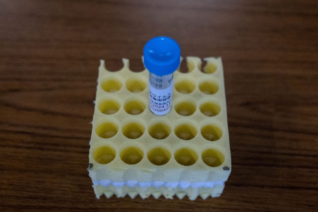 A container which is used to collect samples is seen before a demonstration of the polymerase chain reaction (PCR) swab test for the COVID-19 coronavirus at a centre in Shinagawa in Tokyo on May 8, 2020. (AFP)