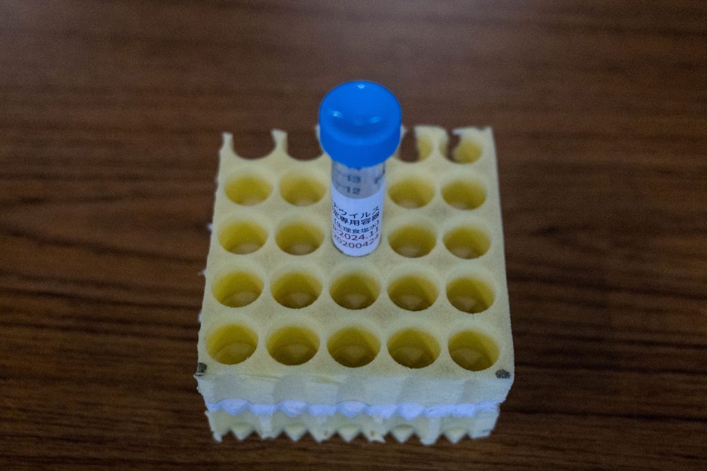A container which is used to collect samples is seen before a demonstration of the polymerase chain reaction (PCR) swab test for the COVID-19 coronavirus at a centre in Shinagawa in Tokyo on May 8, 2020. (AFP)