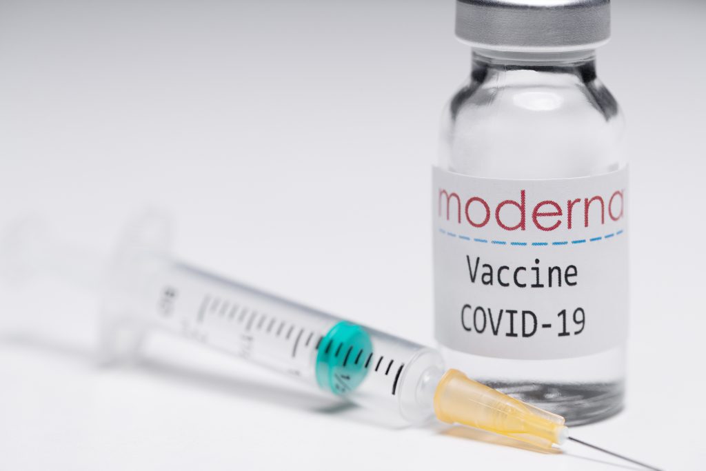 This creative image taken in a studio in Paris on November 16, 2020, showing a syringe and a vaccine vial with the reproducted logo of a US biotech firm Moderna, illustrates the announcement of an experimental vaccine against Covid-19 from Moderna that would be nearly 95% effective, marking a second major step forward in the quest to end the Covid-19 pandemic. (AFP)