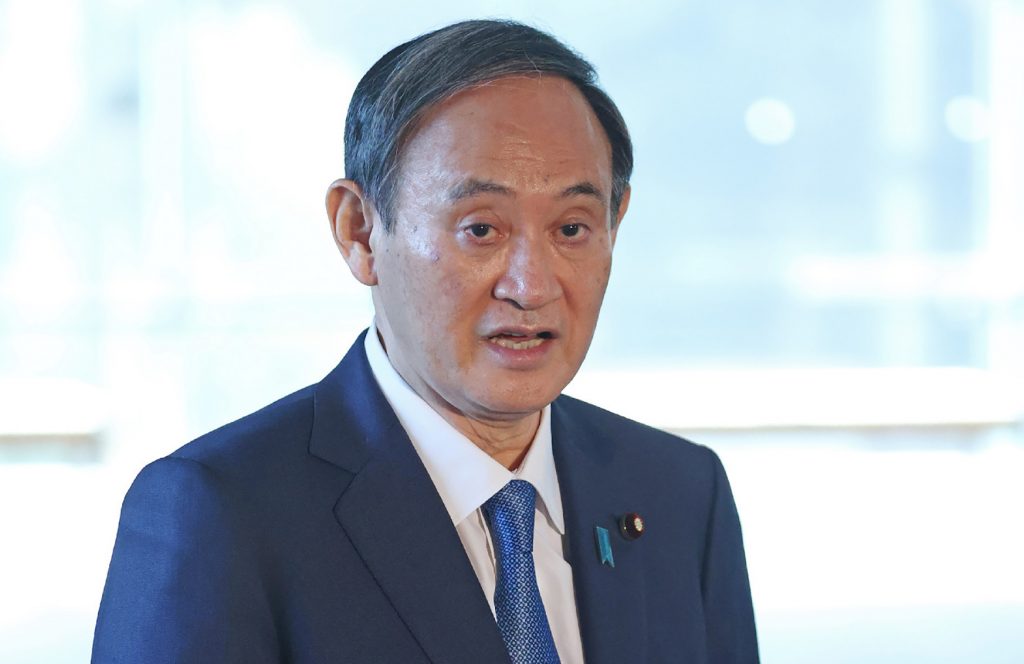 Japanese Prime Minister Yoshihide Suga answers reporters' questions about measures against the Covid-19 coronavirus at the prime minister's office in Tokyo, Nov. 19, 2020. (AFP)