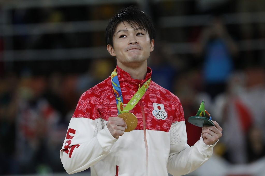 Japan's Kohei Uchimura poses with his gold medal on the podium of the men's individual all-around final of the Artistic Gymnastics at the Olympic Arena during the Rio 2016 Olympic Games in Rio de Janeiro on August 10, 2016. (AFP)
