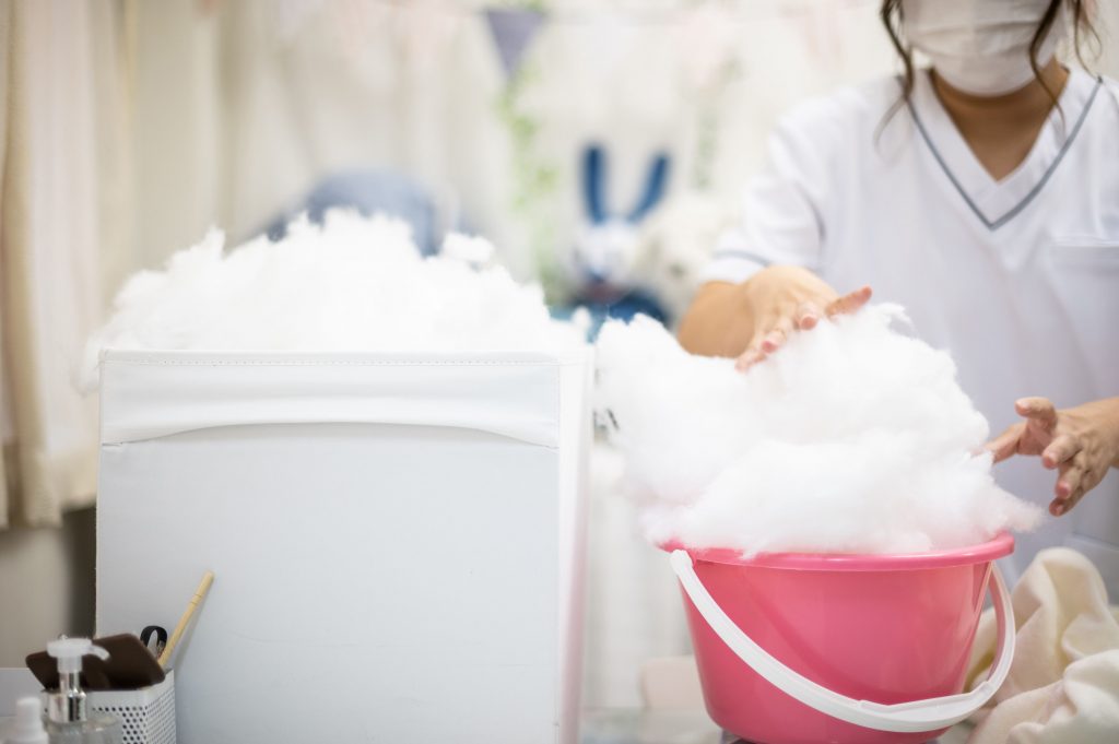 Founder Natsumi Hakozaki working on client Yui Kato's stuffed toy sheep Yuki-chan at Natsumi Clinic in Toyko. The clinic specialises in restoring much-loved teddies and other cuddly toys to their original glory, delighting deeply attached owners like Yui Kato, who brought in the sheep. (File photo/AFP)